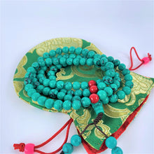 Load image into Gallery viewer, prayer beads mala turquoise coiled on bag